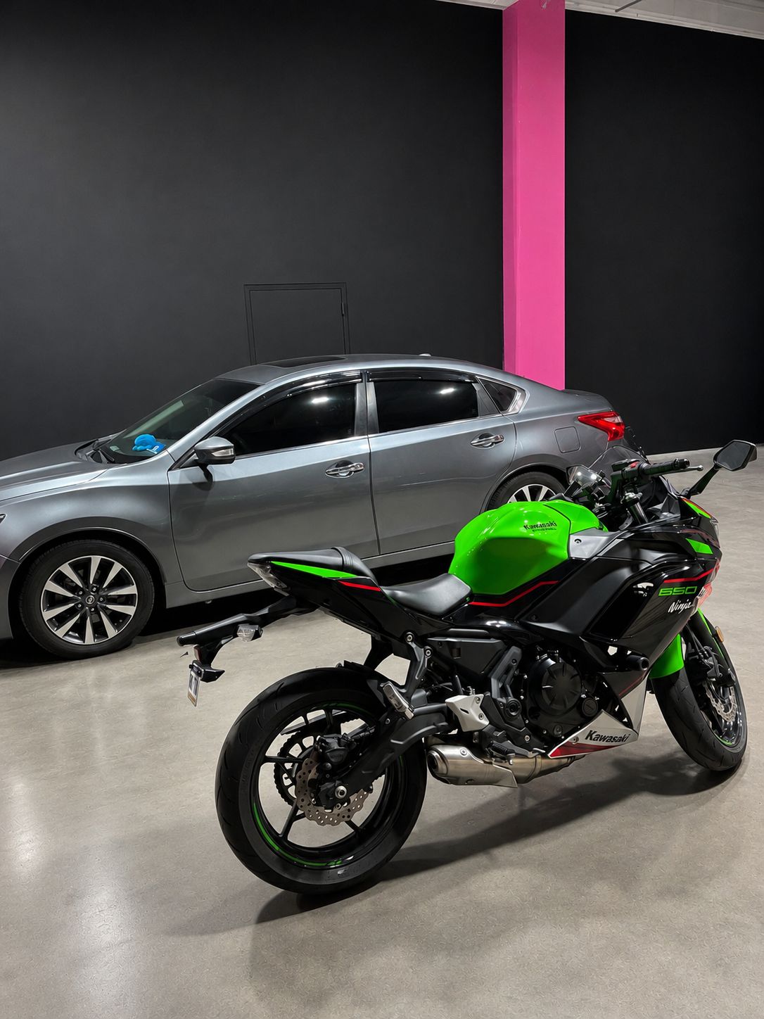 Tinted sedan and Kawasaki Ninja at the shop
